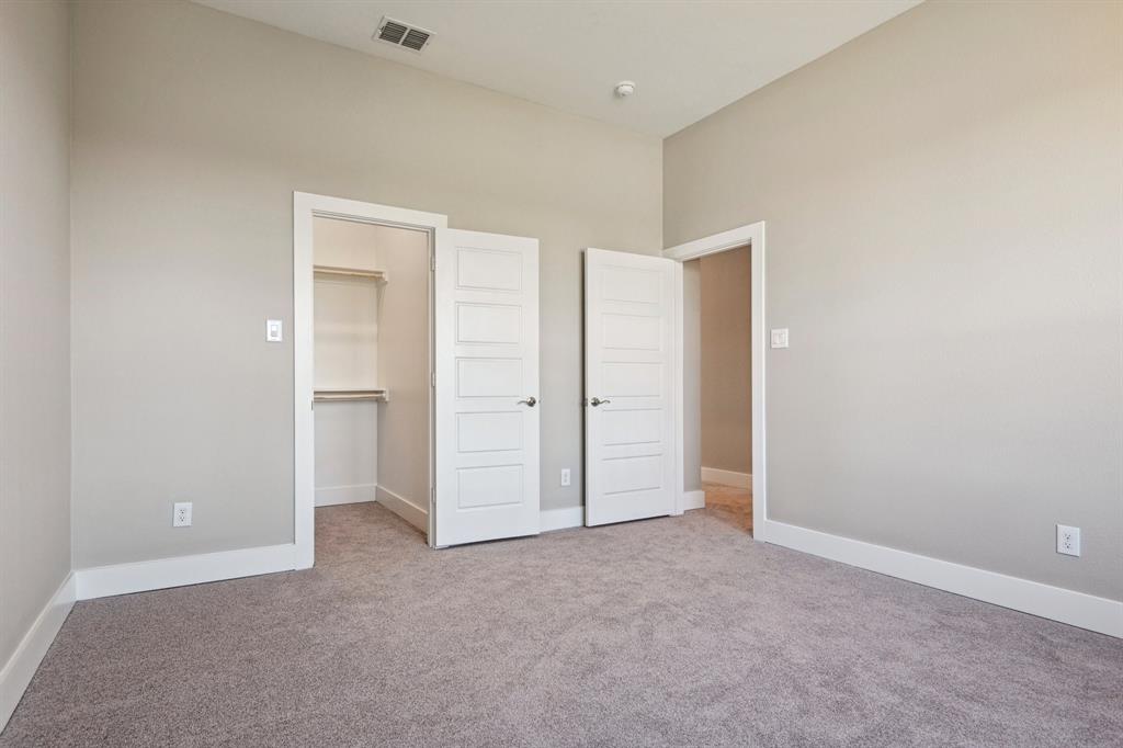 1711 Paytyn Drive Allen, TX 75013 - Photo 27 of 37 Unfurnished bedroom featuring a spacious closet, light carpet, and a closet