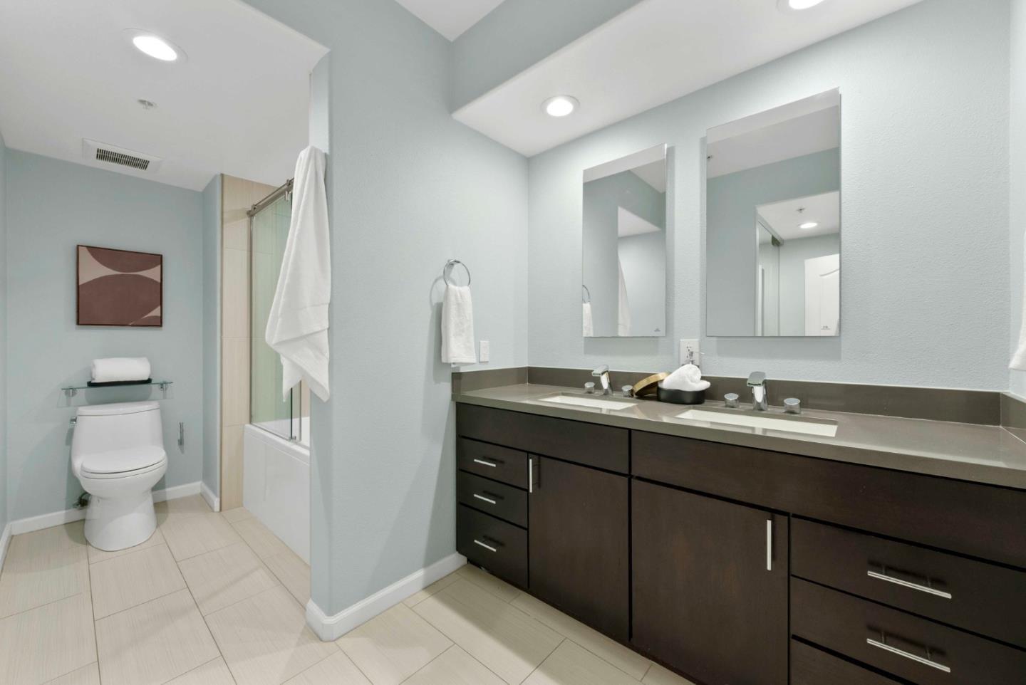 144 South 3rd Street, Unit 508 San Jose, CA 95112 - Photo 14 of 23 a bathroom with a double vanity sink and a toilet