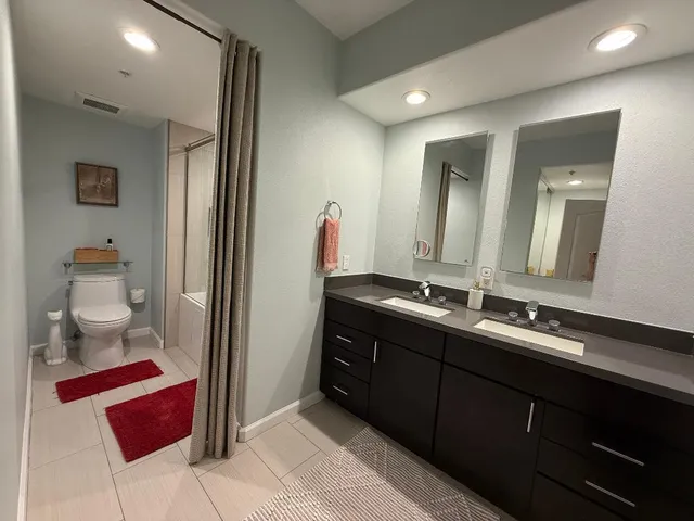 a bathroom with a double vanity sink and a mirror