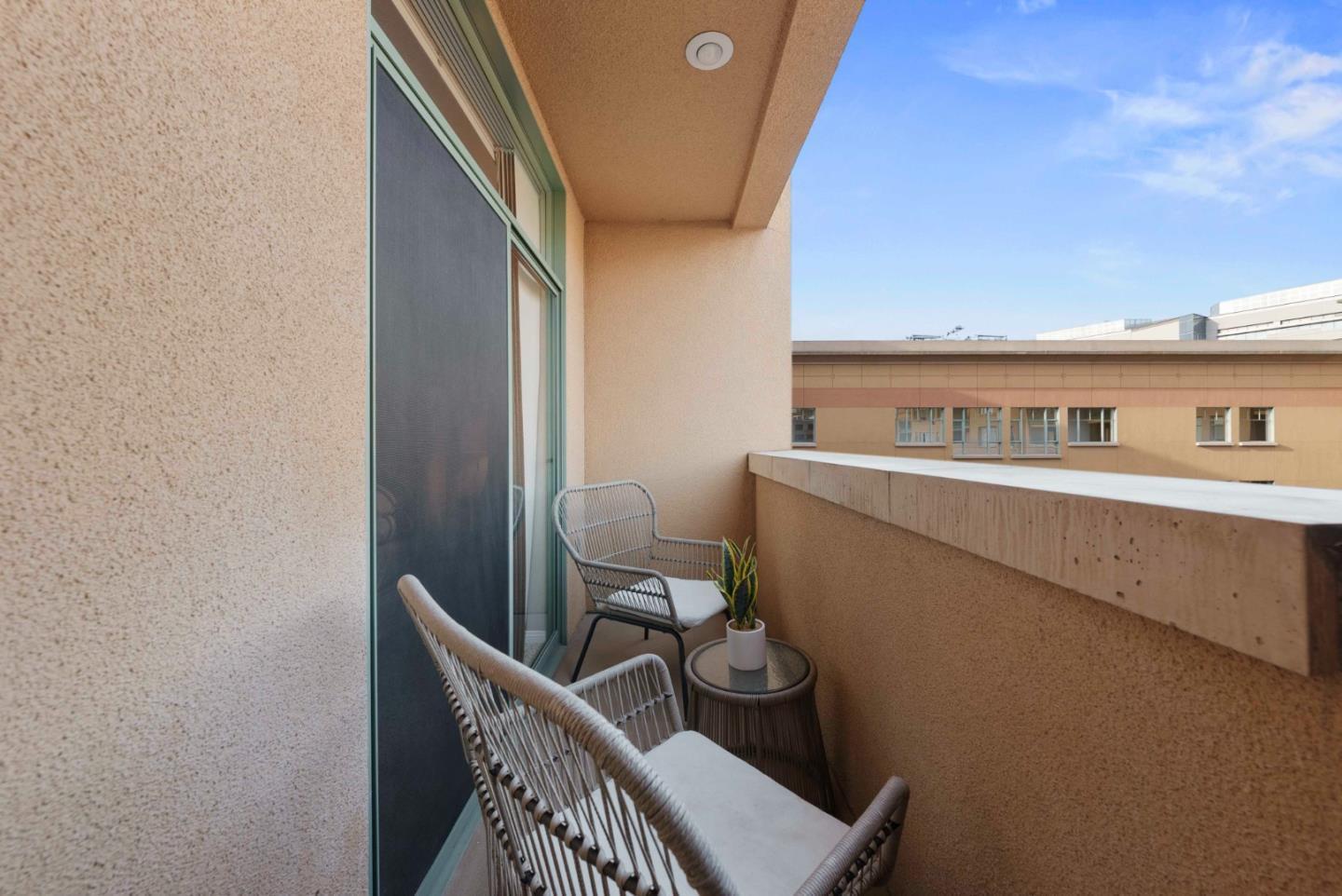 144 South 3rd Street, Unit 508 San Jose, CA 95112 - Photo 20 of 23 a balcony with a table and chairs
