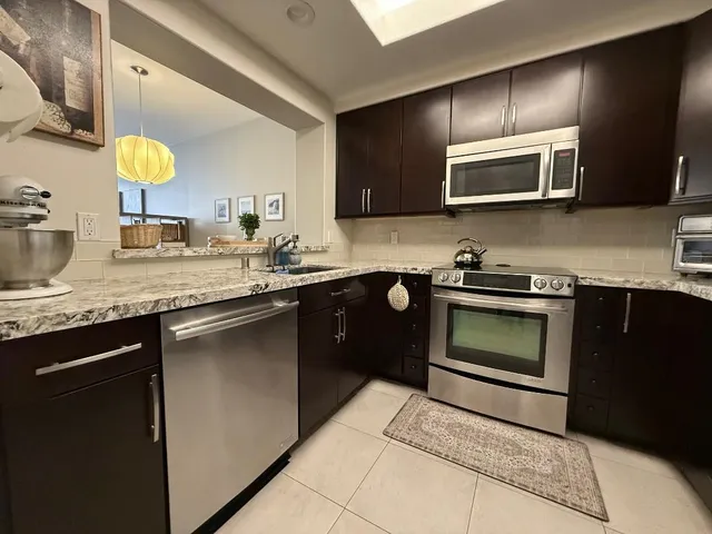 a kitchen with a sink and a stove top oven