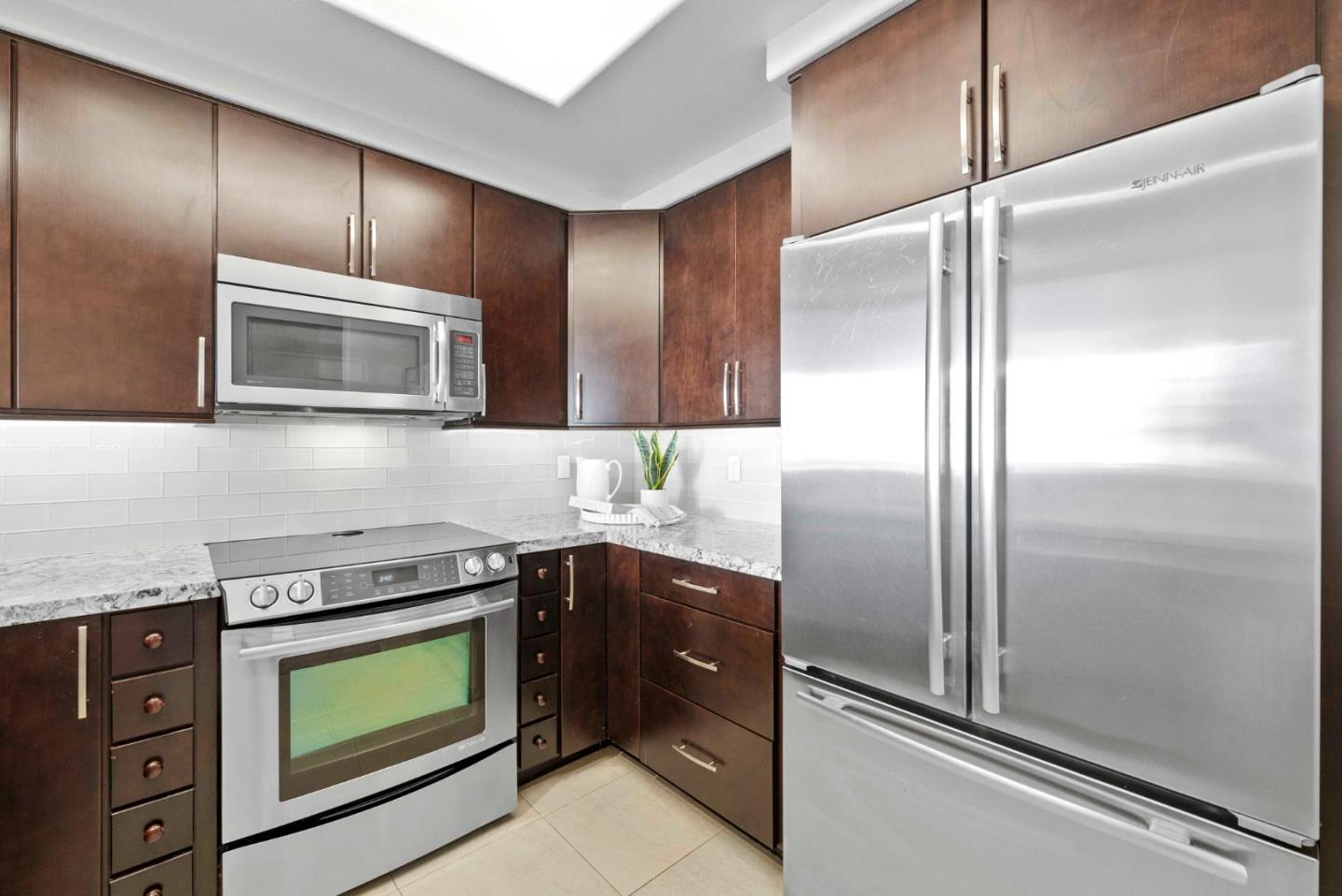 144 South 3rd Street, Unit 508 San Jose, CA 95112 - Photo 4 of 23 a kitchen with stainless steel appliances granite countertop a refrigerator and a sink