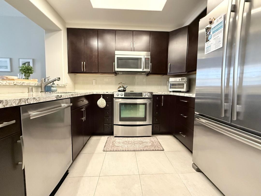 144 South 3rd Street, Unit 508 San Jose, CA 95112 - Photo 5 of 23 a kitchen with stainless steel appliances granite countertop a sink stove and refrigerator