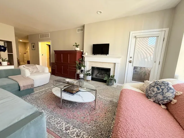 a bedroom with furniture and a fireplace