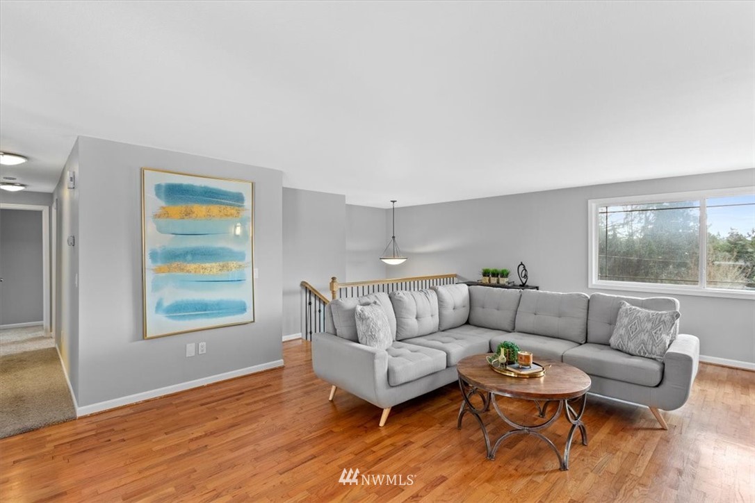 17526 Southeast 135th Street Renton, WA 98059 - Photo 6 of 37 a living room with furniture and a wooden floor