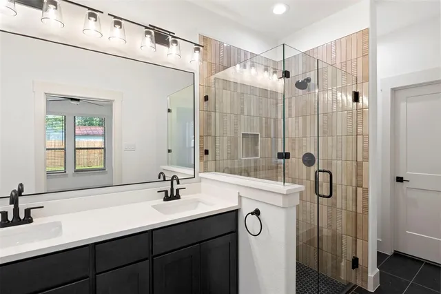 a bathroom with a shower sink and mirror