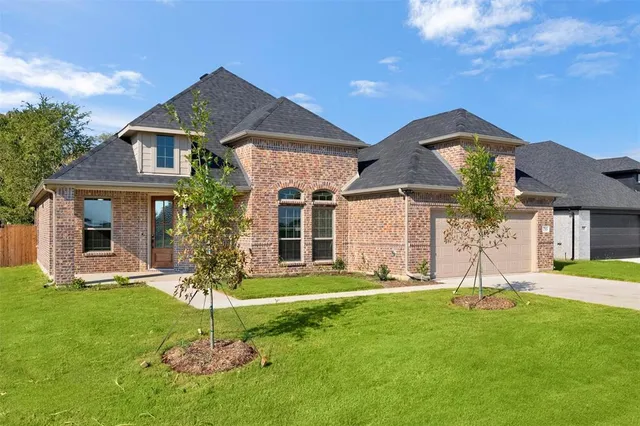 a view of a house with a yard and a garden
