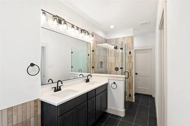 a bathroom with a double vanity sink mirror and