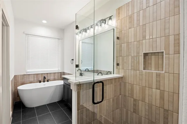 a bathroom with a bathtub and shower