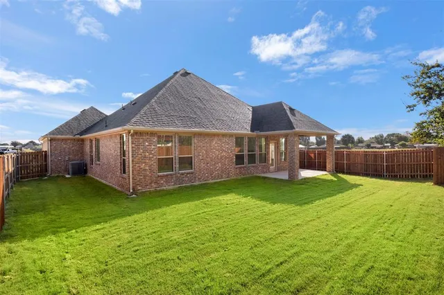a view of a house with a yard and a garden