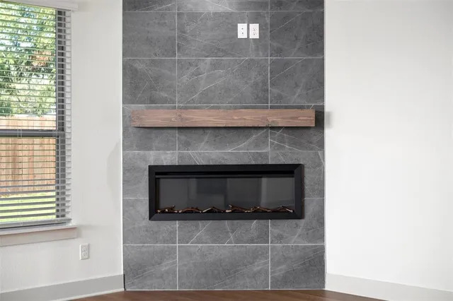 a living room with a fireplace and a window