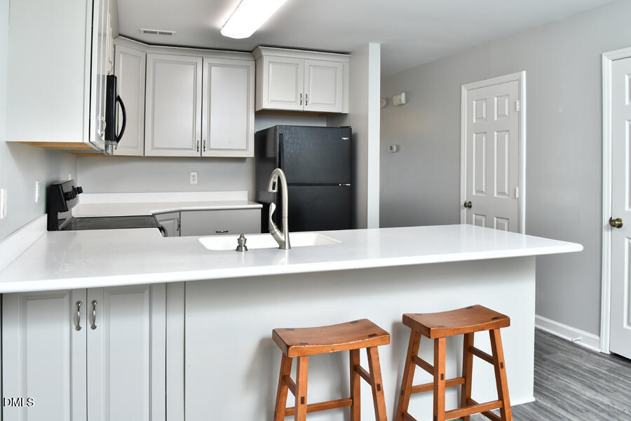 6 Justin Court Durham, NC 27705 - Photo 11 of 22 a kitchen with cabinets and stainless steel appliances