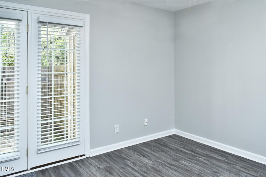 6 Justin Court Durham, NC 27705 - Photo 13 of 22 a view of an empty room with wooden floor and a window