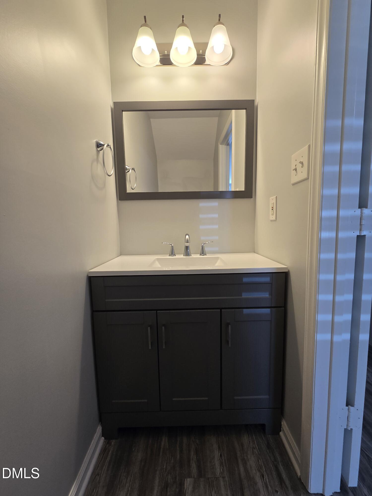 6 Justin Court Durham, NC 27705 - Photo 16 of 22 a bathroom with a sink and a mirror
