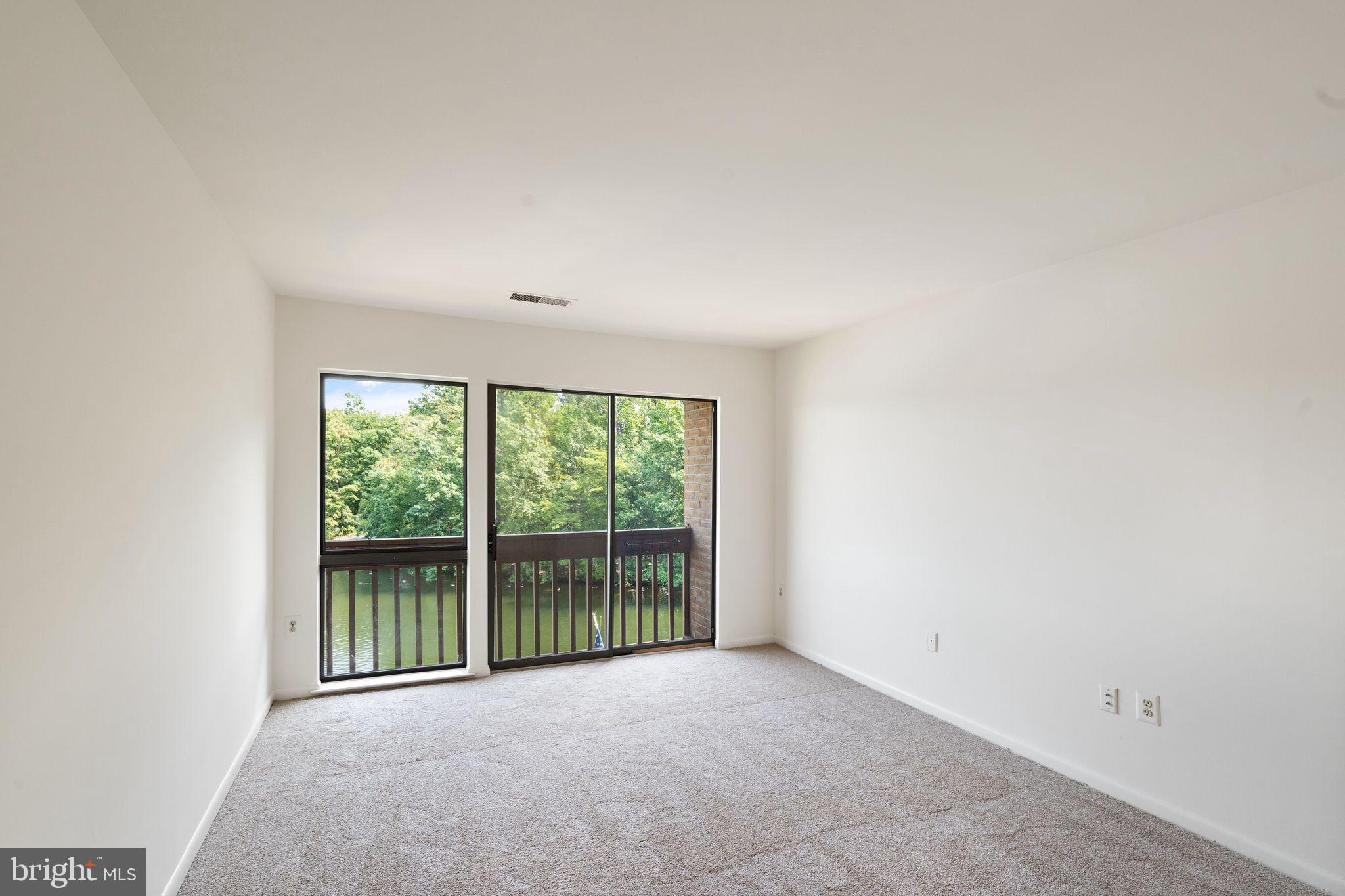 11200 Lagoon Lane Reston, VA 20191 - Photo 50 of 84 Primary bedroom w/ balcony lakeside