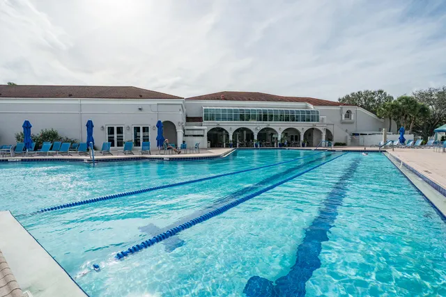 a view of a patio with table and chairs under an umbrella