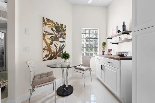 a bedroom with a bed a mirror and lamp