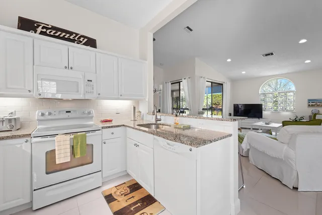 a kitchen with stainless steel appliances cabinets and a window
