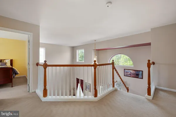 a view of a hallway with a livingroom and a couch