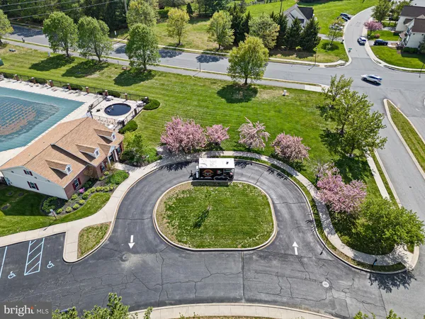 an aerial view of a house with garden space and street view