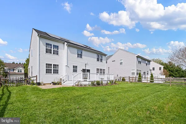 a front view of house with yard and outdoor seating