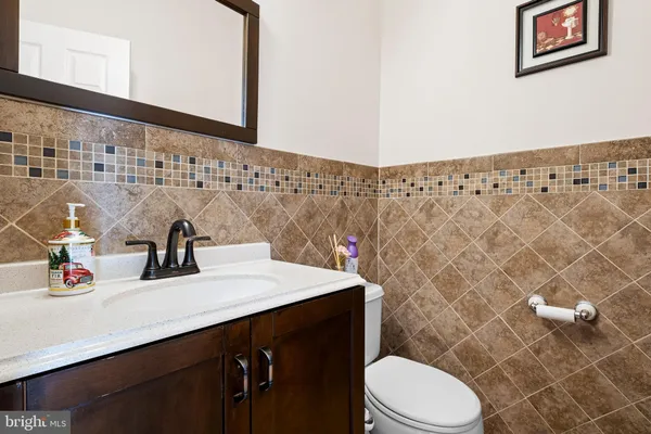 a bathroom with a sink a toilet and a mirror