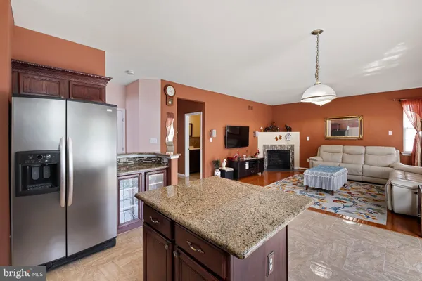 a kitchen with stainless steel appliances granite countertop a sink refrigerator and cabinets