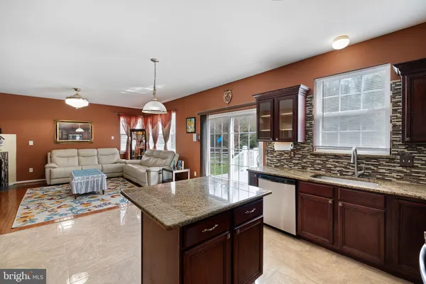 a kitchen with granite countertop a stove and cabinets
