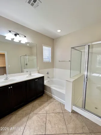a bathroom with a bathtub a sink and a mirror