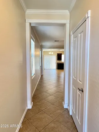 a view of a hallway with wooden floor and a living room