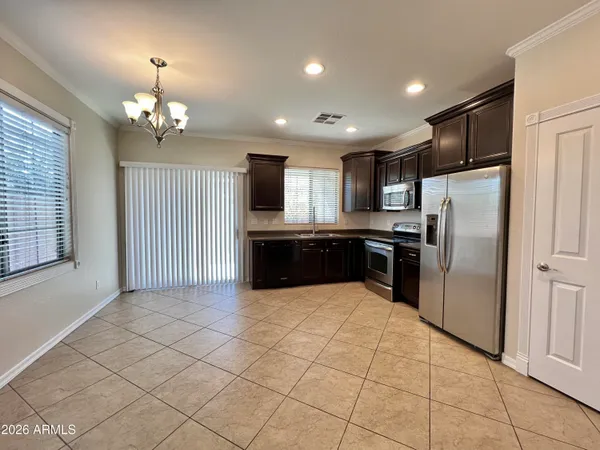a kitchen with granite countertop a refrigerator and a sink