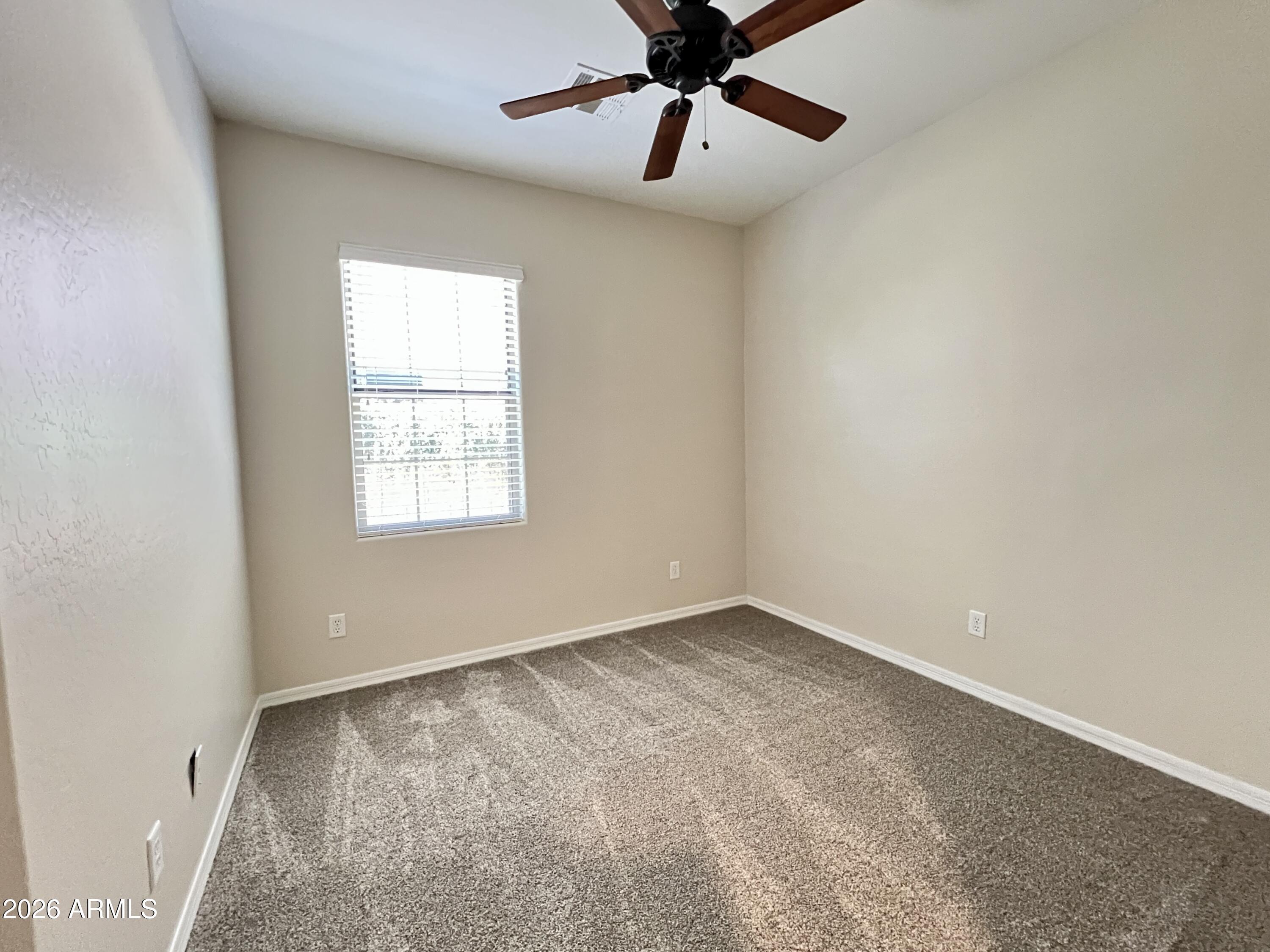 865 East Del Rio Street Chandler, AZ 85225 - Photo 9 of 15 an empty room with a window and a fan