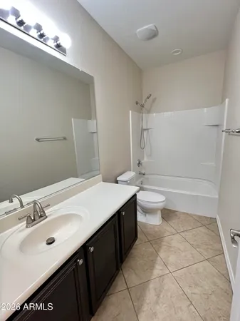 a bathroom with a double vanity sink mirror and toilet