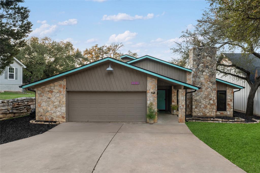 2210 Red Fox Road Austin, TX 78734 - Photo 7 of 40 A stone-accented facade and inviting teal door welcome you to this charming residence.