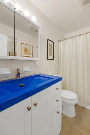 a view of a balcony with chairs and wooden floor