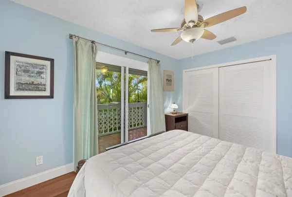 a room with lots of wooden furniture and glass door