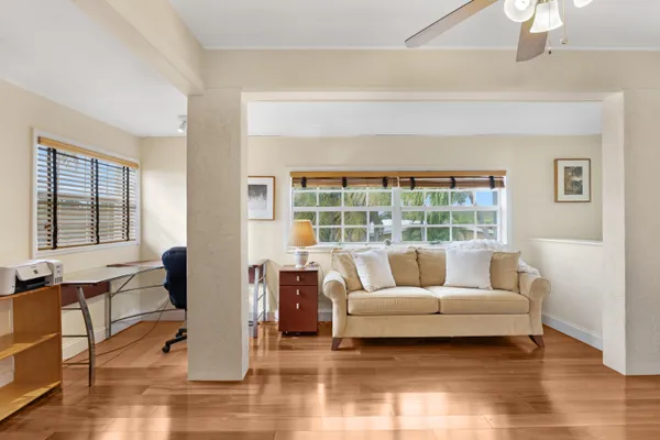 a dining room with lots of tables a chandelier and kitchen view