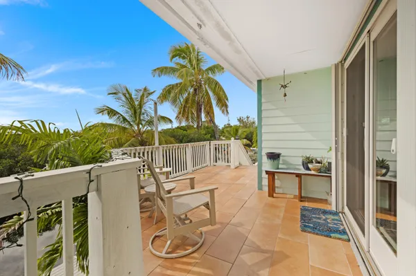 a view of swimming pool with a table and chairs in patio