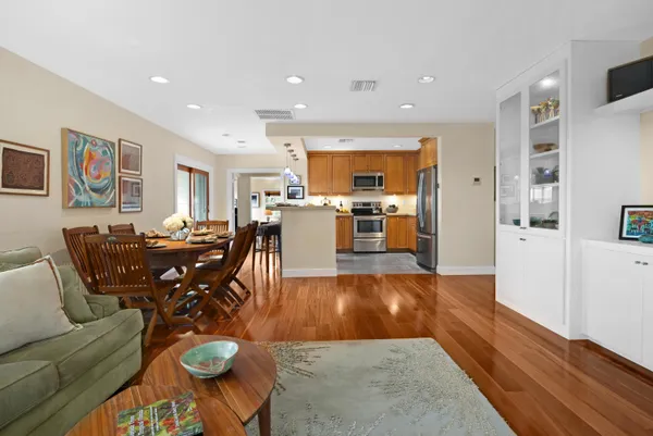 a view of hallway with livingroom and wooden floor