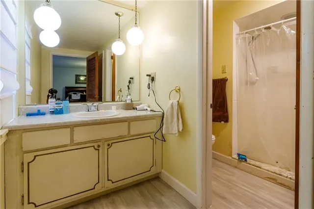 a bathroom with a sink mirror and vanity