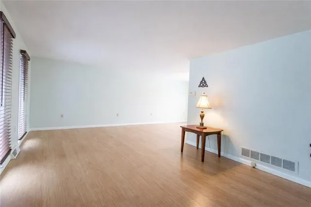 a view of an empty room and wooden floor