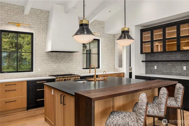 a kitchen with stainless steel appliances granite countertop a stove and refrigerator