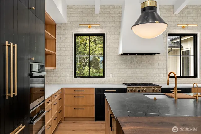 a living room with furniture a fireplace and a chandelier