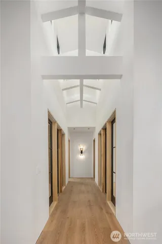 a bedroom with a large bed and a chandelier