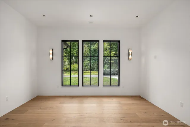 a front view of a house with a yard and potted plants