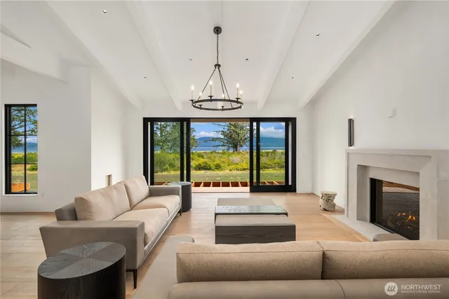 a living room with furniture and a chandelier