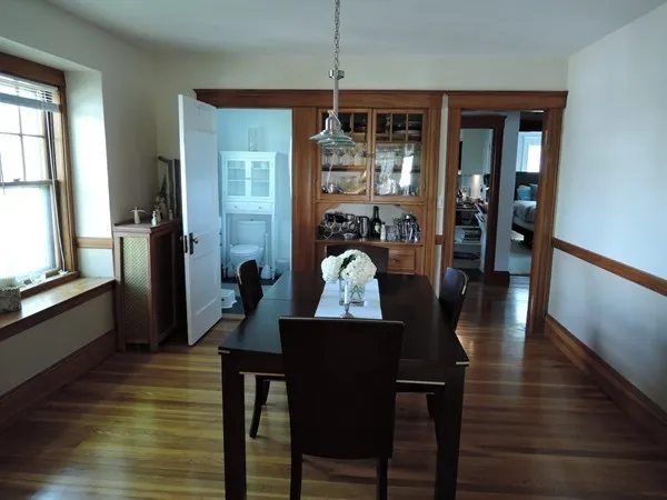 a view of a dining room with furniture window and wooden floor