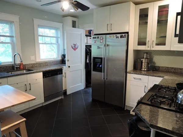 a kitchen with stainless steel appliances a sink stove and refrigerator