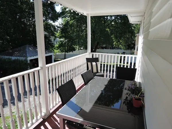 a view of balcony with wooden floor and outdoor seating