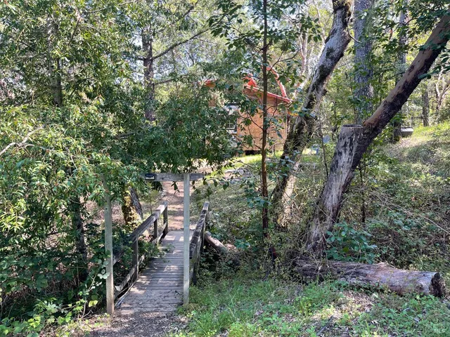 a backyard of a house with yard and outdoor seating